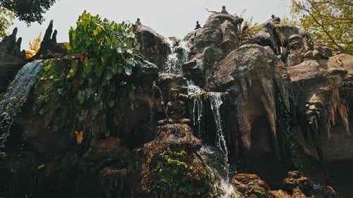 Waterfall Streams Cascade From Height and Water Flows Smoothly Among Stones
