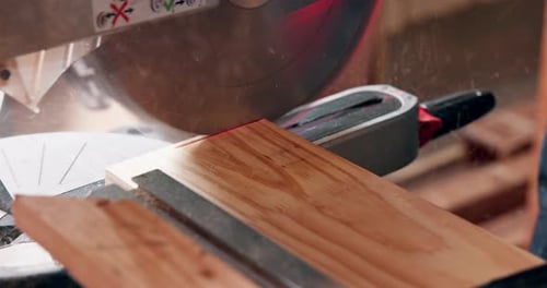 Saw, machine and closeup in workshop with wood project in carpentry and process of cutting plank