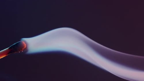 White Smoke From an Extinguished Match on Dark Background