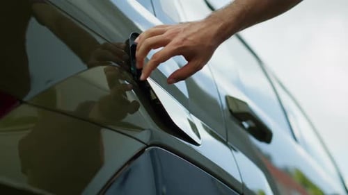 Close Up of Driver Recharging EV Vehicle Battery Low Angle Shot