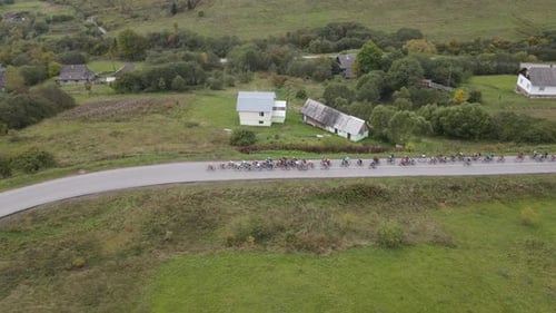 Close Up Aerial View of Village Road People Riding Bicycles Lots of Participants of Sports