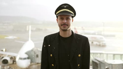 Airline Captain Pilot in Uniform Preparing for Flight at Airport Treminal Gate