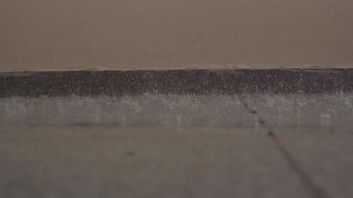 Closeup Shot of Rain Falling on Floor