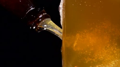 Beer being poured into glass in close up