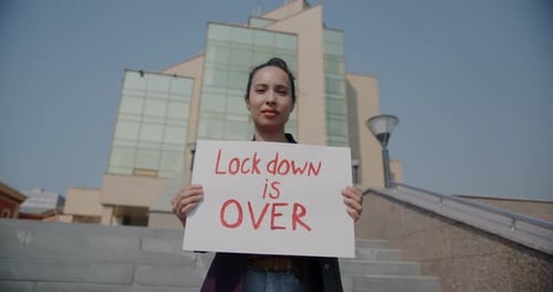 Portrait of Young Lady Holding Lockdown is Over Sign Feeling Hope After the End of Pandemic Standing