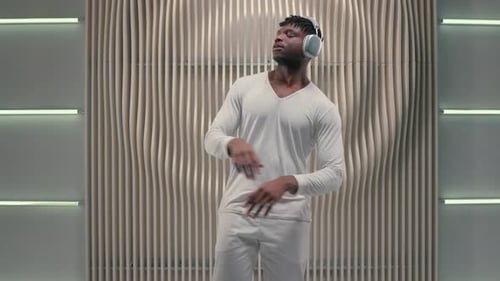 Man with Headphones Dancing to Music Indoors