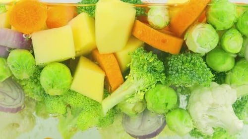 Vegetable mix for making soup in boiling water with air bubbles.