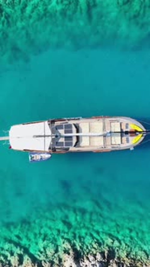 Aerial view of boat on turquoise ocean waters