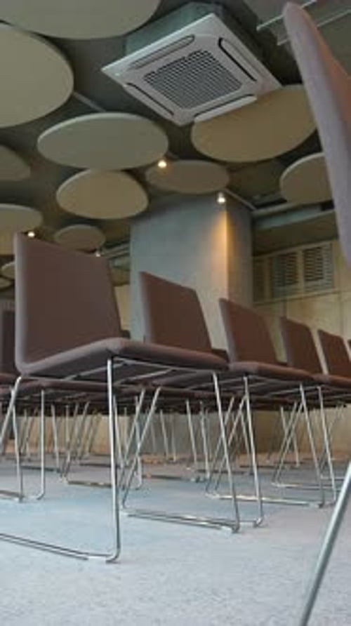Empty Conference Hall with Rows of Chairs