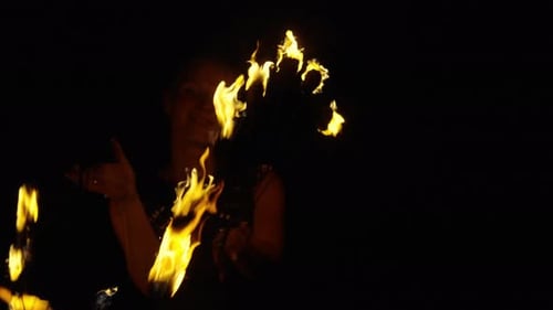 Woman Performing Fire Dance in the Dark