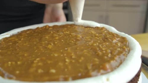 Close Up of Woman Hands Making Sweet Cake with White Cream and Biscuit