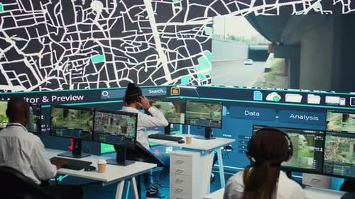 Diverse Employees Operators Tracking Delivery Cars on Satellite Navigation