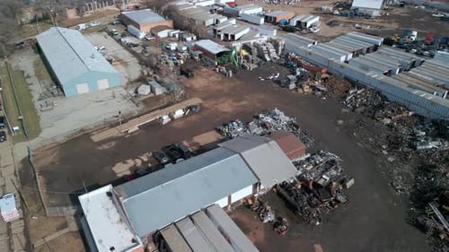 Wide Aerial Above Shot of Loader Grabbing Metal Scrap and Loading on Day Time