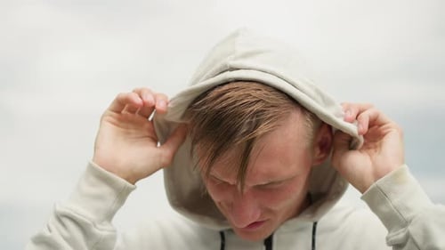 Youthful Urban Anticipation Young Man on City Rooftop White Male Under Cloudy Sky in Urban Setting