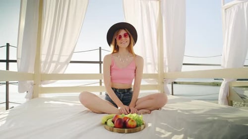 Woman on Beach Patio with Fruit
