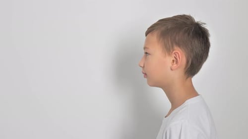 Boy on a White Background Looking at the Camera