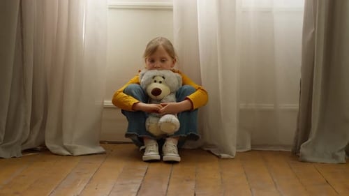 Lonely Sad Little Caucasian Girl Child Kid Sitting on Floor at Home Suffering Domestic Violence