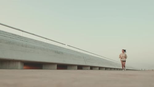 Woman Running on Sidewalk for Health and Fitness