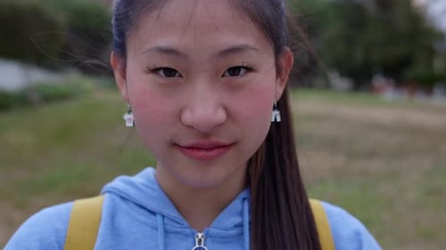 Young Asian Teenage Girl Student Smiling at Camera Standing at School Campus