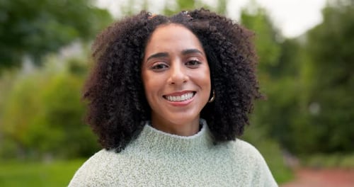 Woman Smiling in a Green Garden