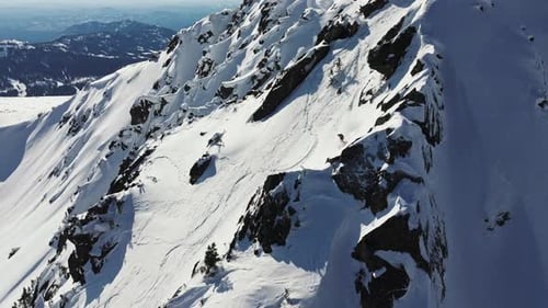 Extreme Skier Descending Snowy Mountain Slope