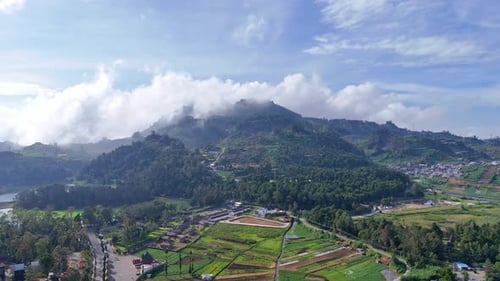 Aerial view of lush green hills and rural landscape in Dieng Plateau, Central Java, Indonesia,