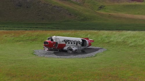 Aerial View of Abandoned Airplane Wreck on Grassy Field in Iceland