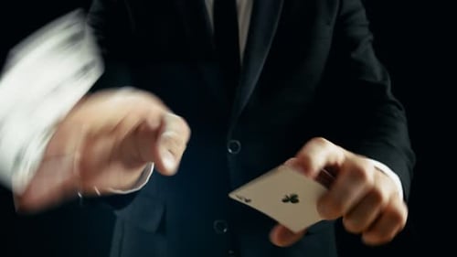 Close-up of a Magician's Hands Performing Card Trick. Throwing and Catching Cards Deck in the Air.