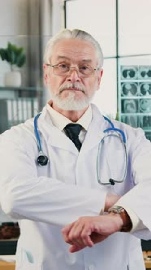 Senior Doctor in White Coat Looking at Camera