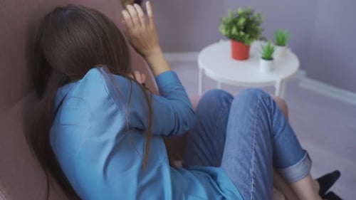 Couple Arguing in Living Room, Woman in Distress