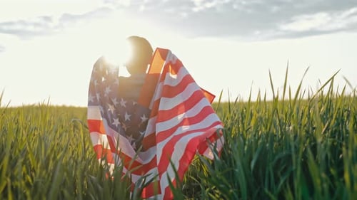 Child Runs with American Flag in Golden Field