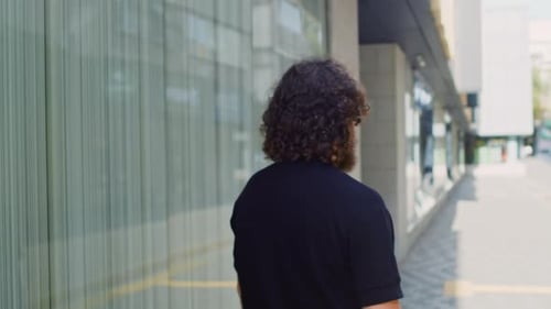 Bearded Caucasian Man Turning Around Crossing His Arms and Smiling Close Up on a City Street Concept