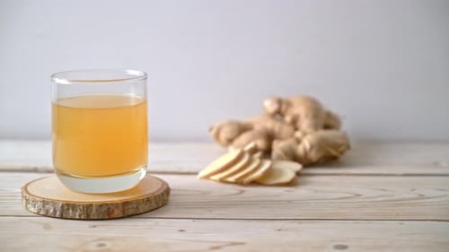 fresh and hot ginger juice glass with ginger roots - Healthy drink style