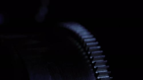 close up of an old clock mechanism clockwork gear reveal from black