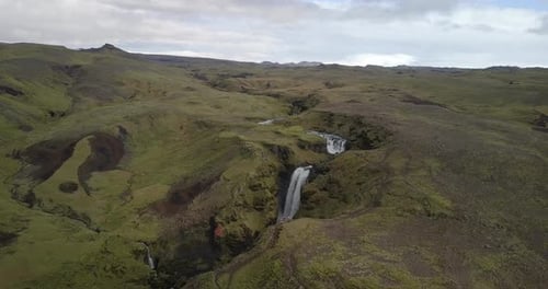 Aerial View of Waterfall in Green Landscape