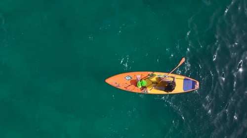 Aerial View Exploring the CrystalClear Waters of a Stunning Mediterranean Lagoon on Paddleboards