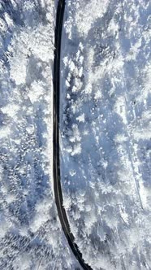 Scenic Road in Snowy Winter Mountains Top View