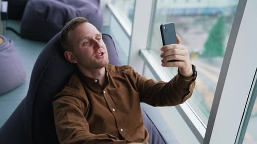 Man Using Phone in Modern Relaxed Office
