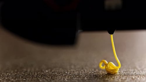 3D Printer Extruding Yellow Filament Close Up