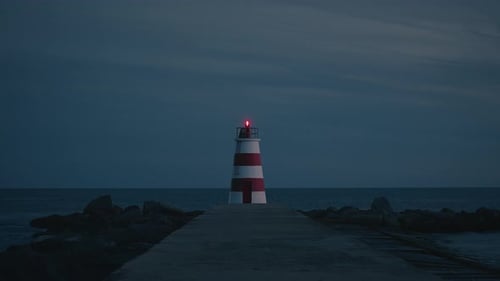 Lighthouse by the coast at dusk after sunset