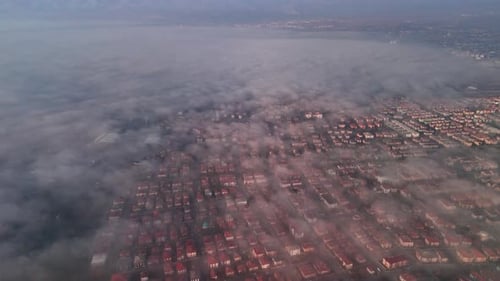 the view of the clouds over the city from the air