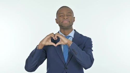 Man Makes Heart Shape with Hands Smiling