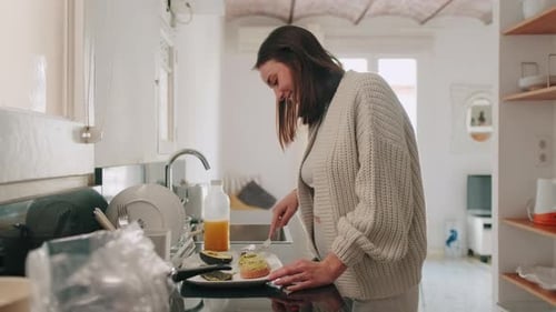 Happy Woman Eating Avocado Toast at Home