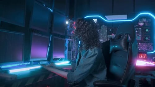 an asian woman programmer is working in her computer room