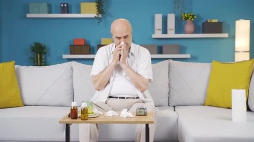 Senior Man Blowing Nose at Home