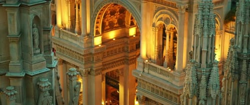 Illuminated classical building with arches seen from cathedral roof at night