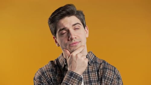 Man Thinking Carefully On Yellow Backdrop
