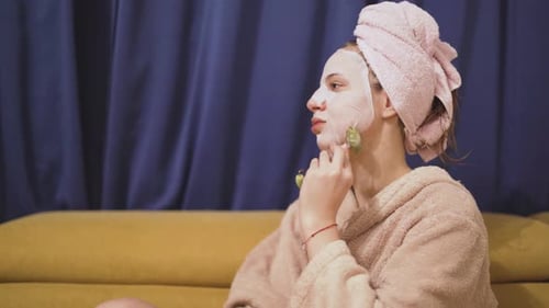 Self Care Routine Blonde Woman with Facial Mask in Bathrobe at Home