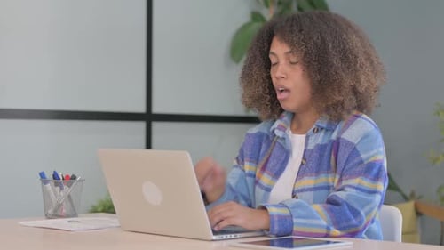 African American Woman Coughing while Working in Office