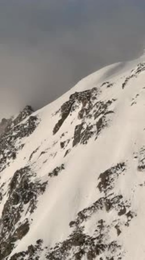 Snowy Mountain Peaks Above The Clouds. British Columbia, Canada.